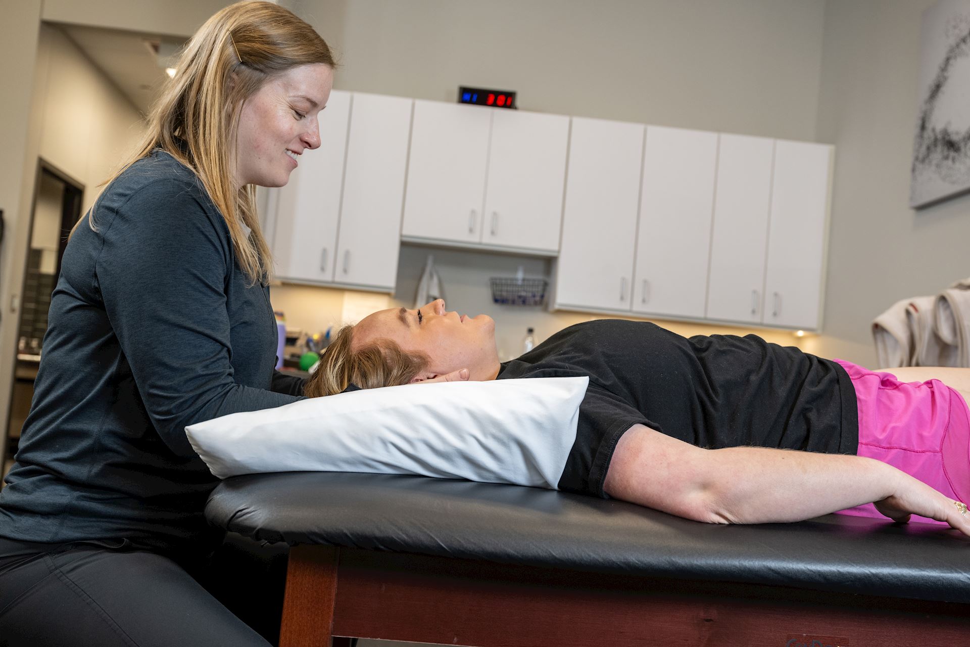 physical therapist working on neck and shoulder area of patient
